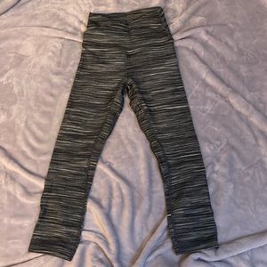 Size 2 length 23 inch Lululemon gray and white leggings with cross waist